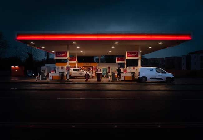 A bright Shell fuel station in the dark